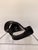 Contemporary abstract sculpture featuring a flowing, ribbon-inspired design in a rich matte black finish. Its graceful,...