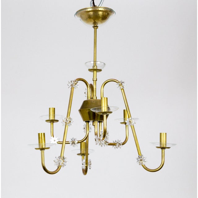 A streamlined, mid-century modern, brass chandelier with six arms swooping up and down from the main stem peice. Delicate,...