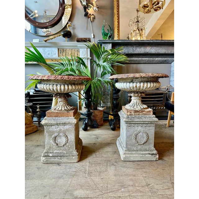 A wonderfully weathered pair of No.9 Tazza urns by renowned foundry Andrew Handyside. A wide and shallow saucer shaped...