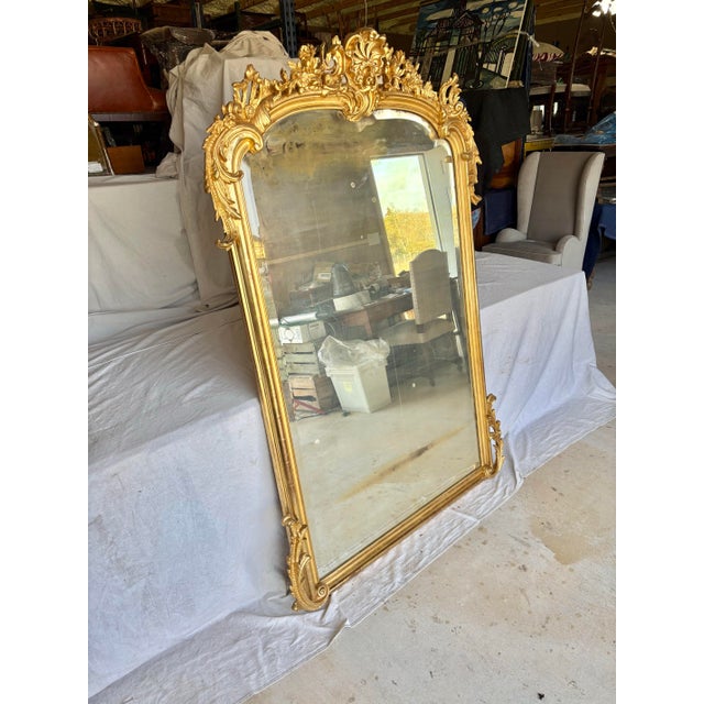 Found in the South of France, this large scale 19th Century French Giltwood Wall Mirror was crafted in the late 1800's in...