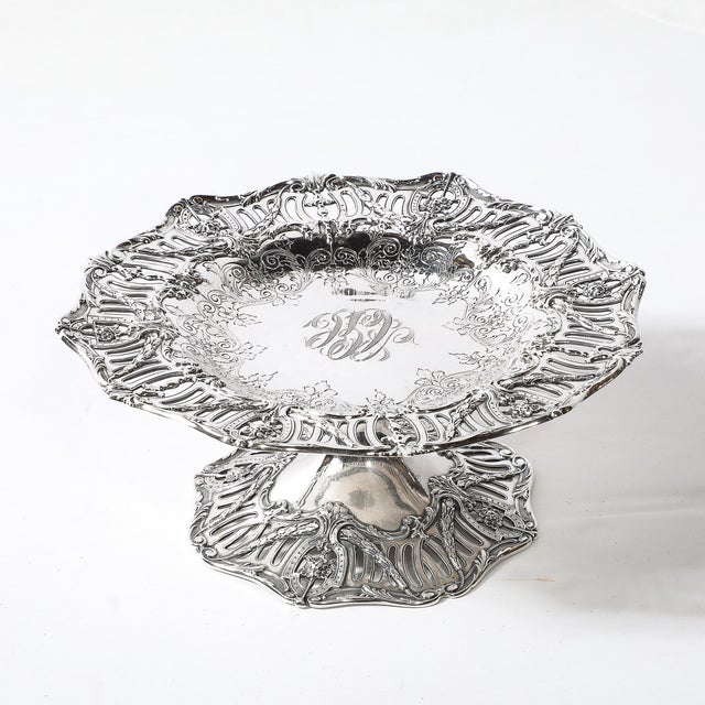 This exquisite pair of sterling silver tazas stands as a testament to the artistry of the Aesthetic Movement, crafted by...