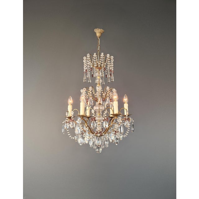 An elegant Italian chandelier featuring refined proportions and subtle colored accents. This piece has been fully restored...