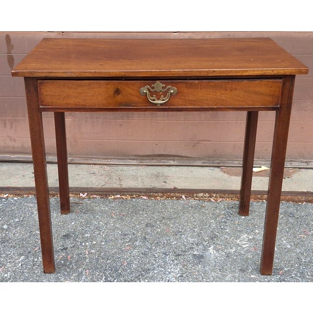 A 19th Century Federal Mahogany Small Writing Table Measures 32" in width and 19" in depth and 28" in height. Knee...
