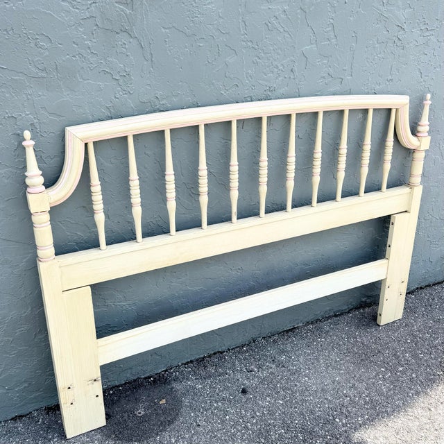 A charming vintage Thomasville queen-size headboard, beautifully finished in a soft coastal cream with delicate blush pink...