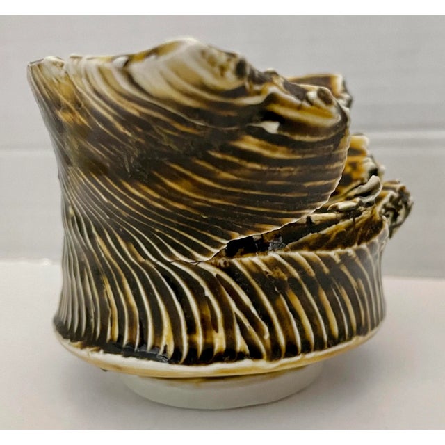 White and brown small Brutalist pottery bowl. Thick and with an irregular shape. Signed and dated 1/99 on bottom.