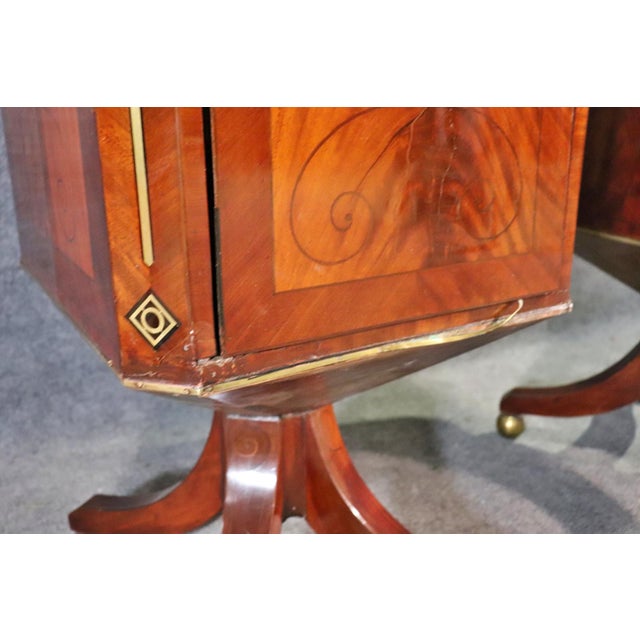Elevate your interior with this rare pair of Edwardian pedestal silverware side cabinets, meticulously crafted from...