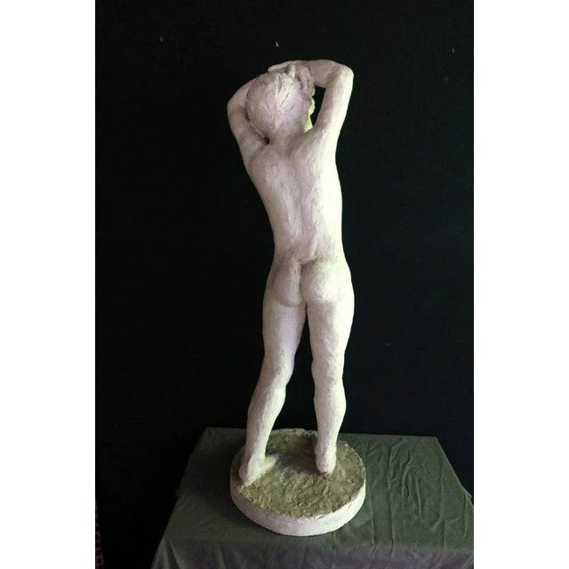 Sculpture in plaster representing a young boy with his arms raised over his head. Signed Chaumel and dated 1939 on the...