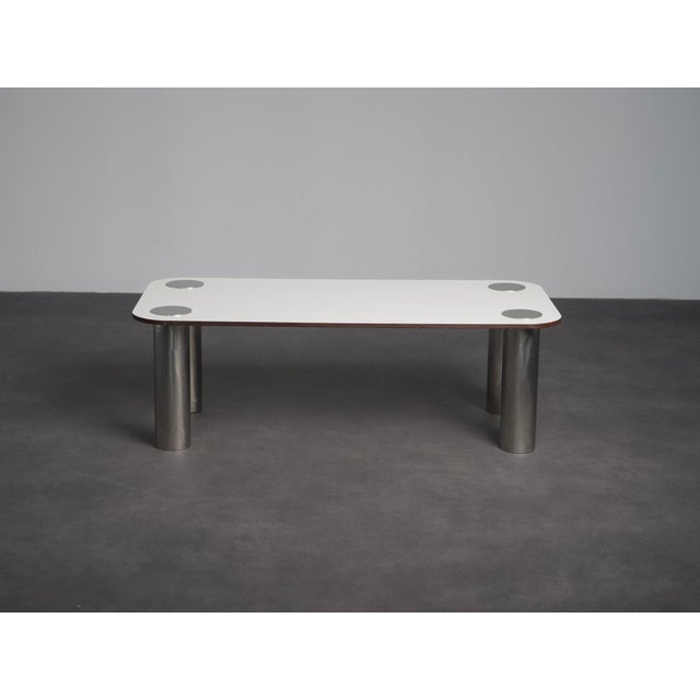 A refined 1970s coffee table designed by marco zanuso for zanotta. The white melamine top with softly rounded corners...
