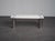 A refined 1970s coffee table designed by marco zanuso for zanotta. The white melamine top with softly rounded corners...