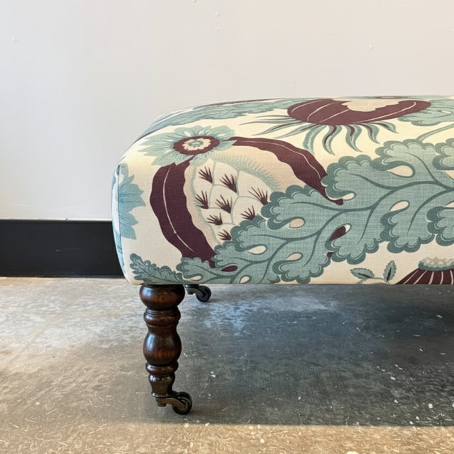 Upholstered in Christopher Farr Carnival Aubergine Fabric. Turned Wood Legs with Casters. Hardwood Frame.