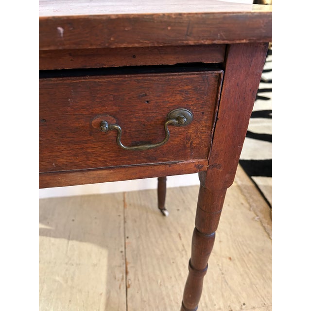 Nice medium sized rustic antique wood side table having single drawer and handsome weathered patina. The small white...