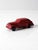 This late 1930s Auburn Rubber Co. toy car, reminiscent of a 1937 Oldsmobile, features a sleek streamlined design in red...