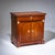 Two-door Empire cabinet with a drawer and flanking bronze pilasters. The mounts are likewise executed in bronze. The doors...