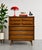 Mid Century Modern walnut dresser by United Furniture Co., c.1960s, featuring striking burl-front top drawers and rich,...