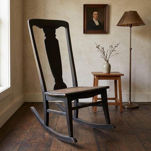 Vintage armless wooden rocking chair with woven cane seat, likely dating to the late 19th or early 20th century. The chair...