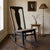 Vintage armless wooden rocking chair with woven cane seat, likely dating to the late 19th or early 20th century. The chair...