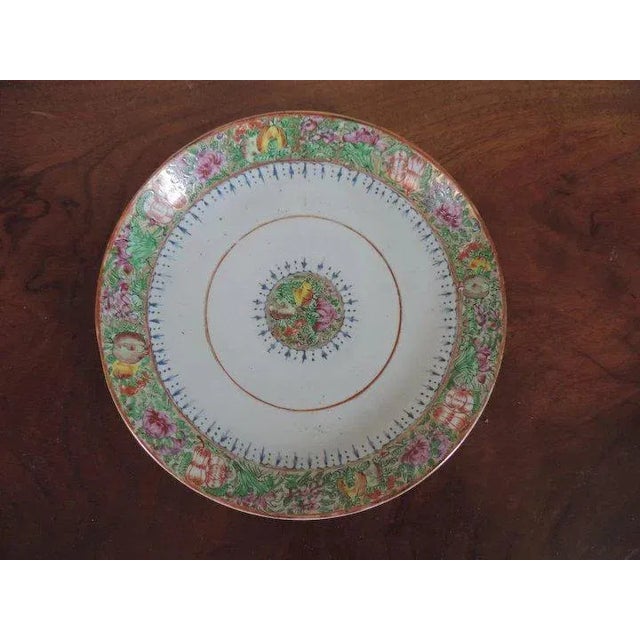 Large antique 19th c. Chinese export porcelain shallow bowl or charger plate decorated in a famille rose palette enhanced...