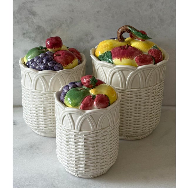 Set of 3 vintage ceramic canisters in a fruit basket design hand painted in Japan by Otagiri. The bottoms of have a...