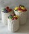 Set of 3 vintage ceramic canisters in a fruit basket design hand painted in Japan by Otagiri. The bottoms of have a...