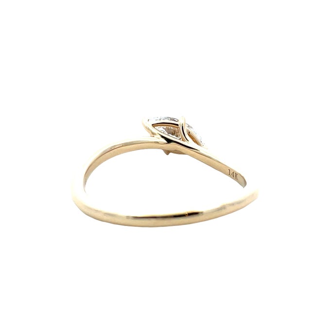 Delicate 14K yellow gold ring featuring a marquise-cut diamond centerpiece accented by the graceful split-style band....
