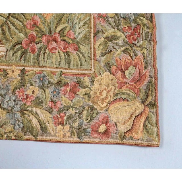 Tapestry with a motif of rich ladies in a garden, having fun digging for treasure. The tapestry is woven using the...