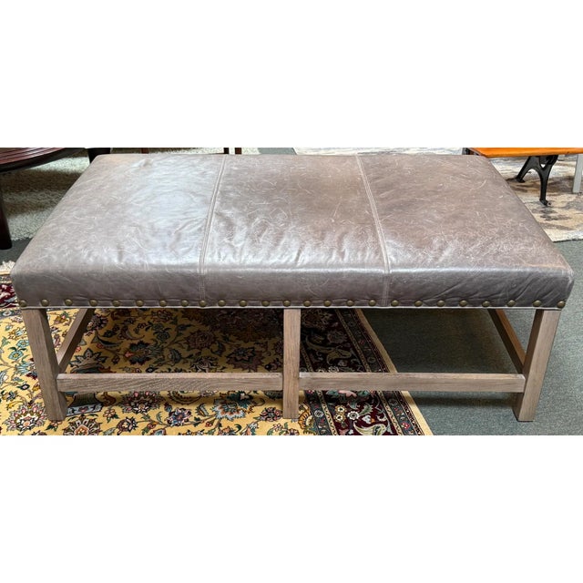 Design Plus Gallery presents an Ottoman from Serena & Lily. The ottoman has a rustic still with a taupe tone of leather...
