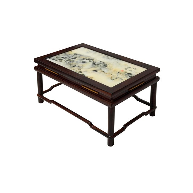 This exquisite desktop stand features a captivating piece of natural stone art set within a rich, dark-toned wooden frame....