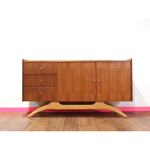 A stunning mid century credenza made by Lebus, this exquisite sideboard offered by Mid Century Traders features gorgeous...