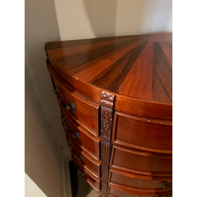 This exceptional vintage demilune console dresser features a striking sunburst inlay top, an elegant bowed front, and a...