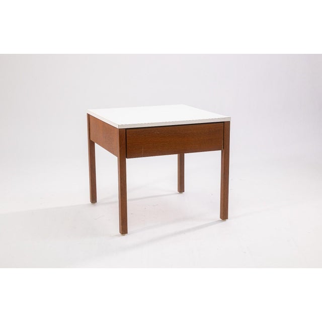 A pair of vintage Florence Knoll side end table nightstands. This pair features a classic mid century modern design with a...