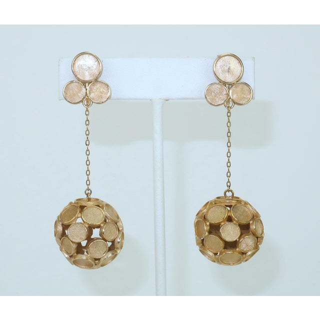 Fashion forward for the 1950's...a pair of Crown Trifari drop dangle earrings consisting of matte gold tone orbs suspended...