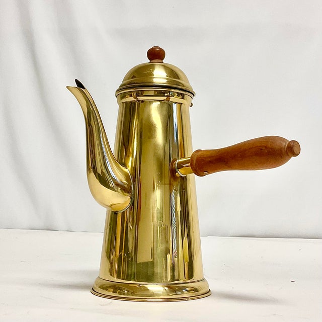 Offering a lovely English style Brass over stainless steel chocolate or coffee pot. It features a long wooden pouring...