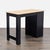 This desk features a stylish two-tone design with a light wood top and black frame. It includes a side cabinet with a...