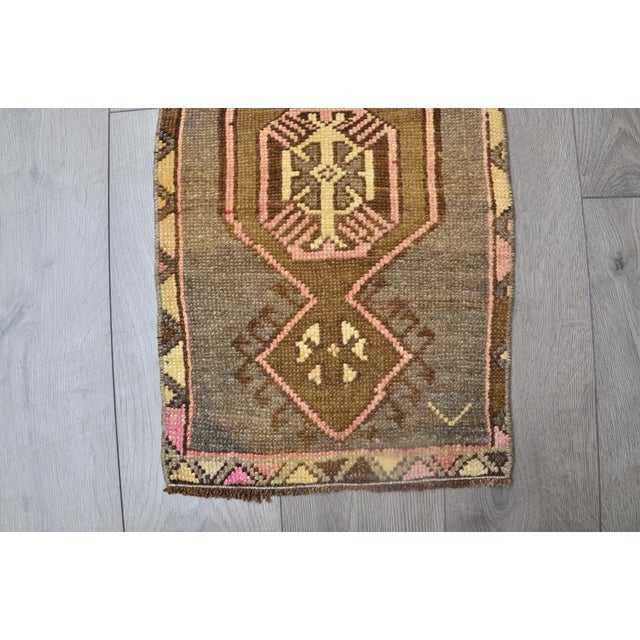 This is a vintage Turkish Oushak rug from the 1960s. The piece was hand-knotted.