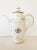 A lovely white bone china coffee pot with gold band accents and petite flowers surround. The makers mark is both on the...