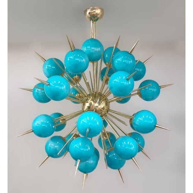 Italian sputnik chandelier with 30 Tiffany blue Murano glass globes and solid brass spikes mounted on brass frame in...