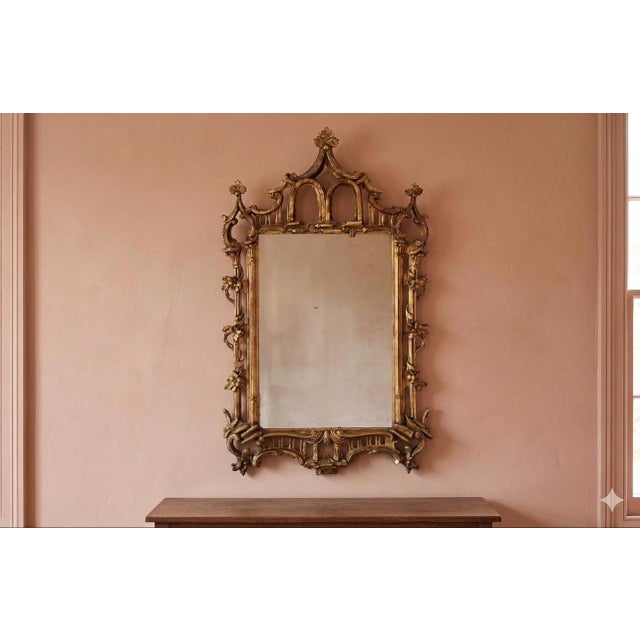 A striking and highly decorative George III period giltwood mirror, dating to the late 18th century, richly carved in the...