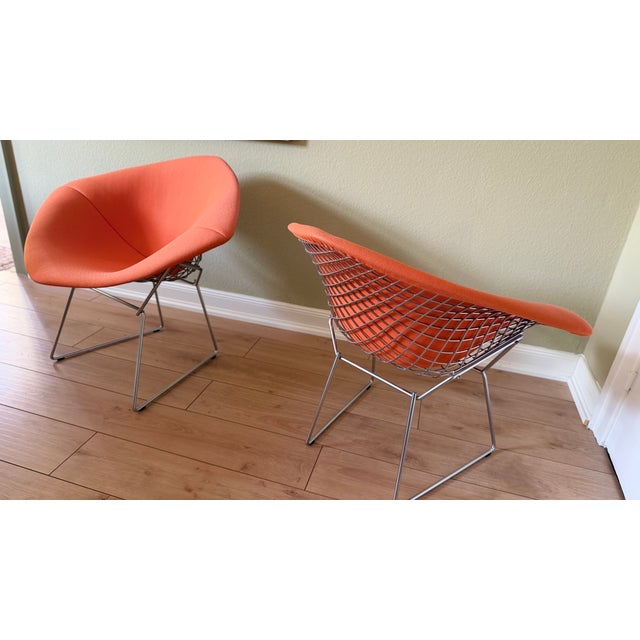 A timeless classic: the beautiful Harry Bertoia Wire Chair Model 421 with peach-orange upholstery for Knoll International....