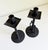 A sculptural pair of wrought iron candle holders featuring a distinct twisted stem design and decorative spiral base...
