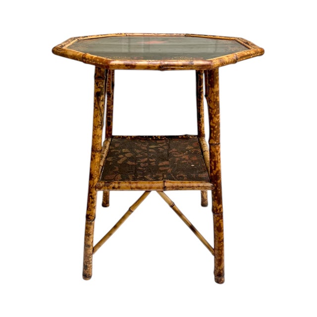 A striking antique Chinoiserie side table crafted from scorched bamboo, featuring an elegant octagonal form and richly...