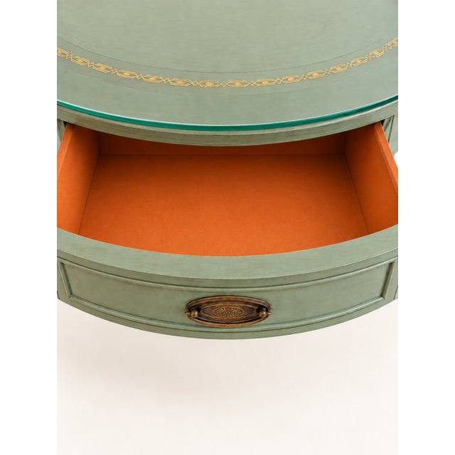 Description: A charming 1940s pedestal table with a circular top, discreet drawer, and sculptural pedestal base with...