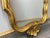 A beautiful Vintage French gilt wall mirror featuring a highly decorative frame with a stunning shell crest and elegant...