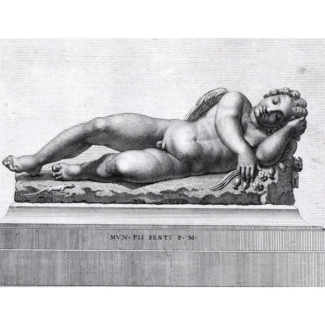 Antique framed etching by V DOLCIBENE (Italian, 18th century) in a silver and black frame. Angel resting on a plinth....