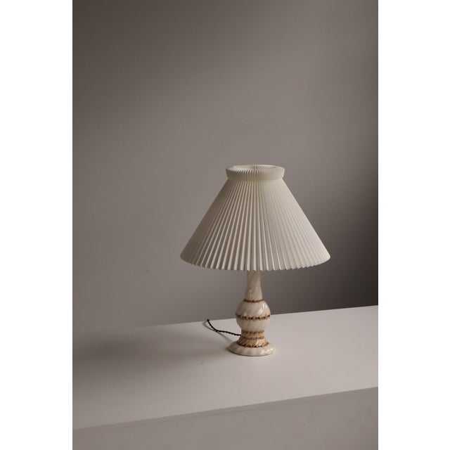 An elegant and exceptionally refined Swedish Grace porcelain table lamp designed by Louise Adelborg, dating to 1926. This...