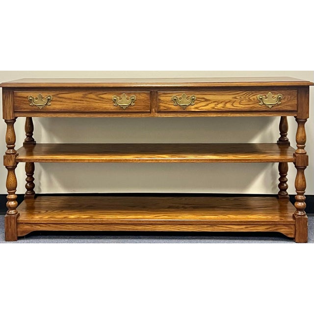 Very nice traditional solid oak console / sofa table by Pennsylvania House. Two dovetailed drawers with brass hardware for...