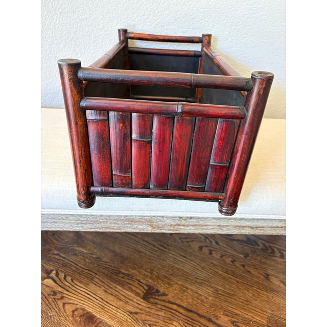 Likely dating to the 1950s, this vintage bamboo planter box features closely spaced bamboo panels and a rich, dark...