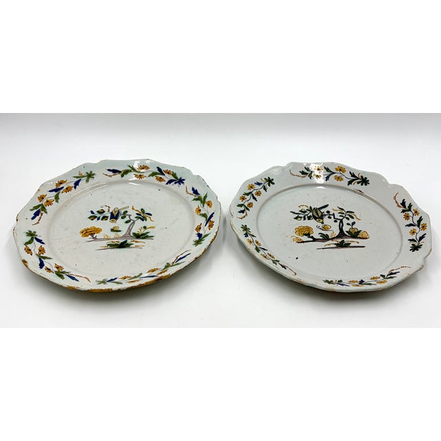 A gorgeous pair of antique 18th-Century faience polychrome plates from the south-west region of France. These charming...