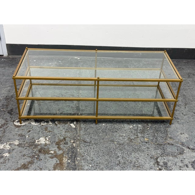 Design Plus Gallery presents the Terrace Coffee Table from West Elm. The rectangular metal frame has an antique brass tone...
