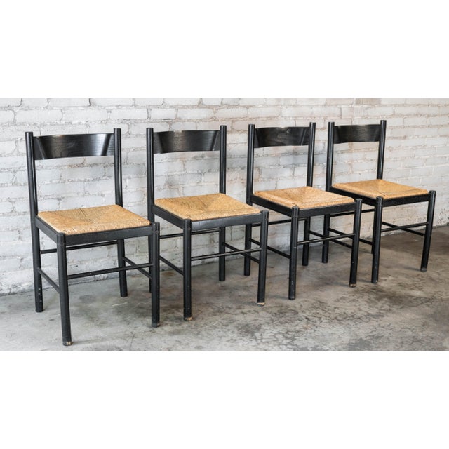 Set of four Italian Postmodern dining chairs in the style of Vico Mattrigetti, circa 1980s. Black wood frame with rush...