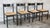 Set of four Italian Postmodern dining chairs in the style of Vico Mattrigetti, circa 1980s. Black wood frame with rush...